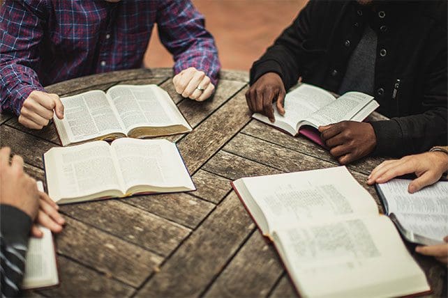 Men listening in a group teaching setting